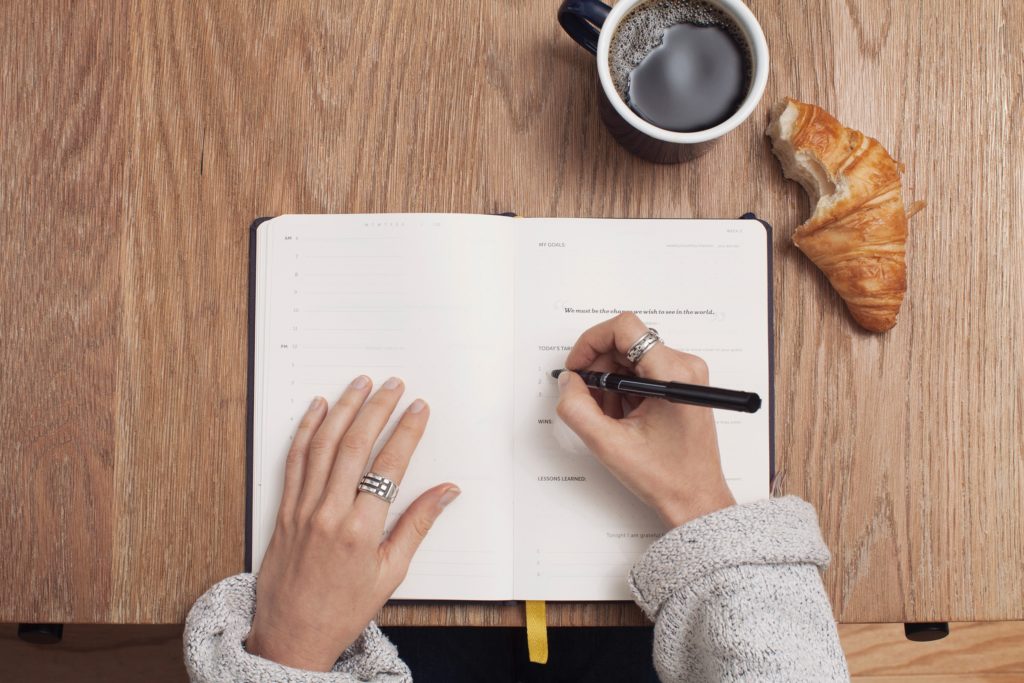 A girl writing her task list