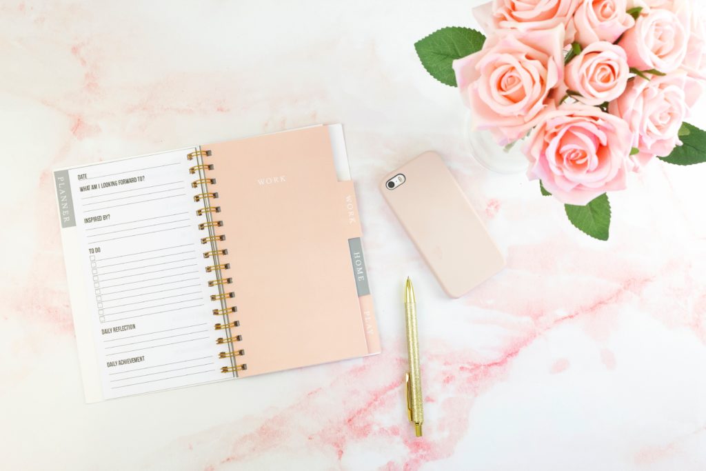 Planner with roses and phone. planning schedule for your passion and full time job